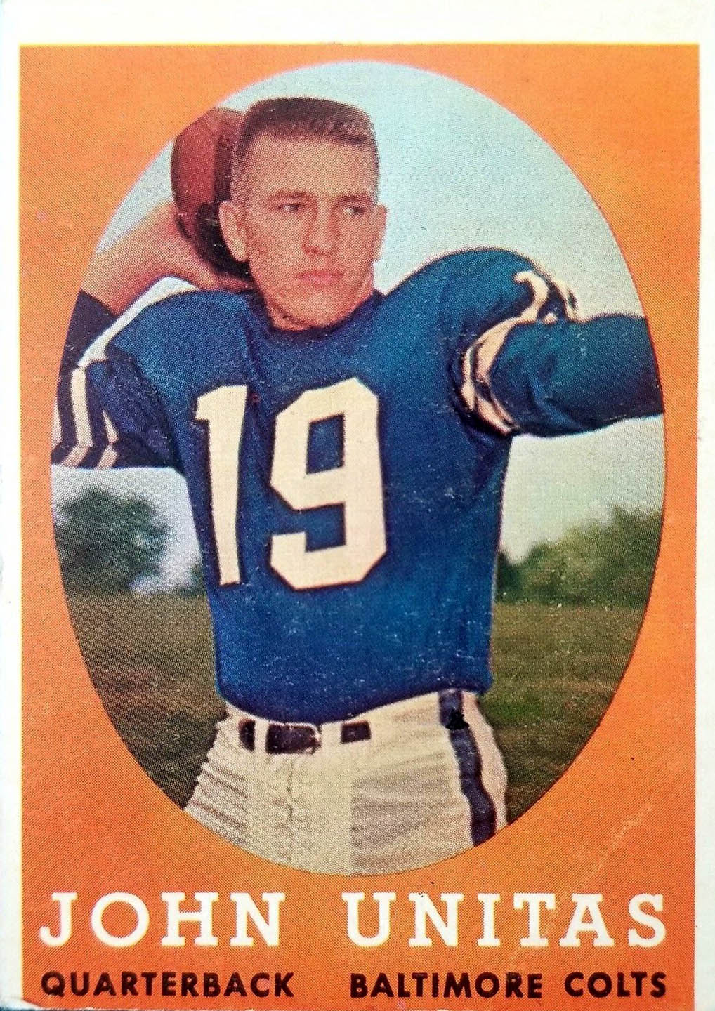 Johnny Unitas’s 1958 Topps #22 complete front: orange background, oval Colts photograph and printed John Unitas caption.