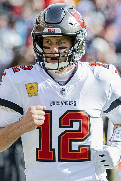 Tom Brady wearing a Tampa Bay Buccaneers helmet and uniform in 2021. Player photograph, not card artwork.